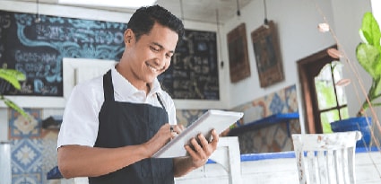Man in a restaurant using a tablet